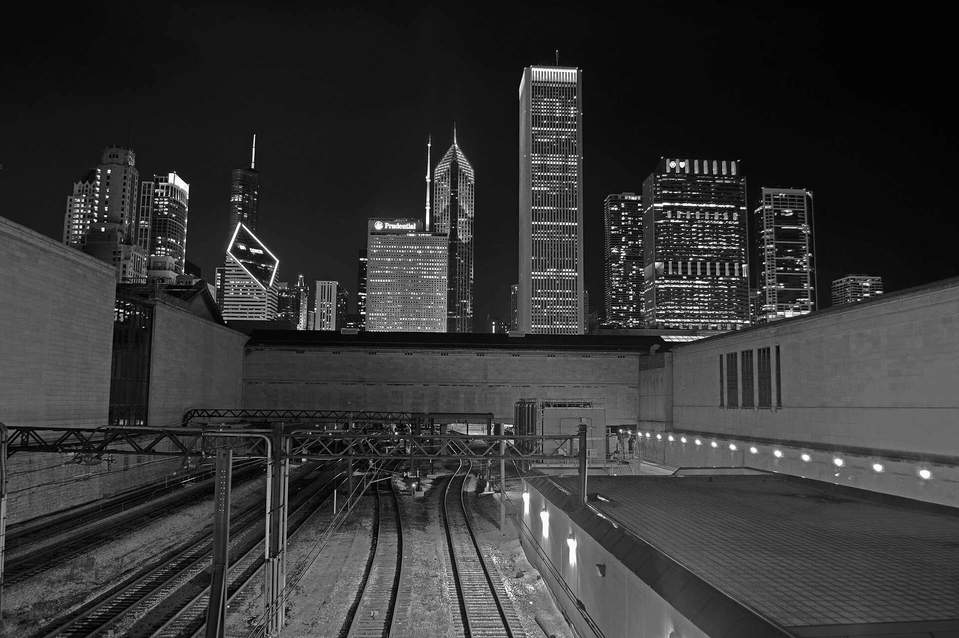 The Chicago skyline at night, seen over the rail tracks south of Millennium Park
